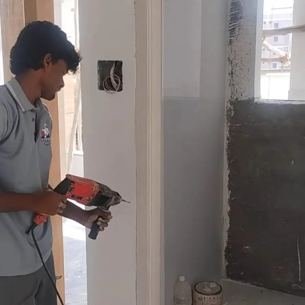 Midhuna technician performing anti-termite drilling
